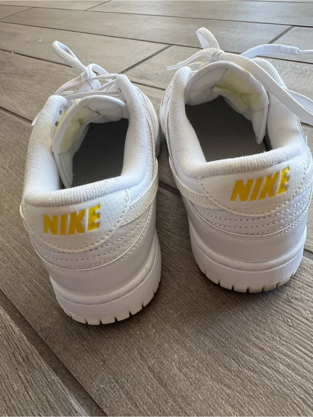Nike White Low-Top Sneakers with Yellow Logo Accents
